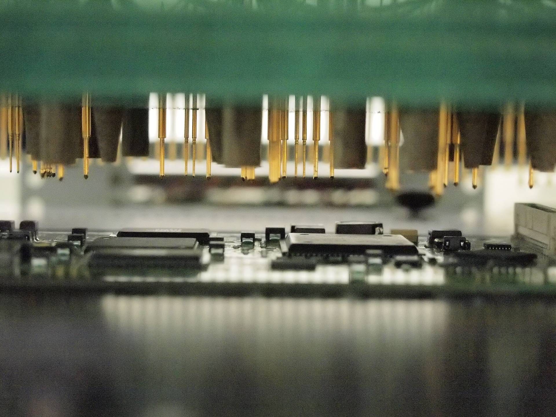 Bed-of-nails ICT test probes over a printed circuit board